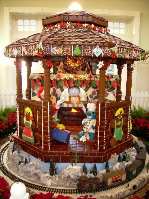 Christmas at Disney's BoardWalk Inn ginger bread house with stitch on fireplace. Keep reading to get your perfect Disney Resort Christmas Decorations Tour!