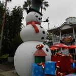 SeaWorld Orlando Christmas Celebration with Snowman in front of gifts.
