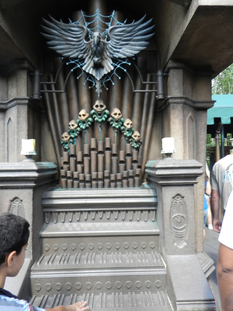Haunted Mansion Magic Kingdom Secrets at Disney with Organ covered in Skulls. Keep reading to learn about the Disney Haunted Mansion Magic Bands.