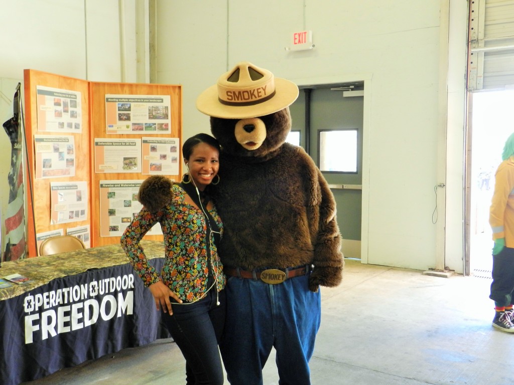 It's me and Smokey the Bear at the Florida State Fair in Tampa 2024. Keep reading to get the full Florida State Fair Guide with Tickets, Food, Concerts, Rides and More!