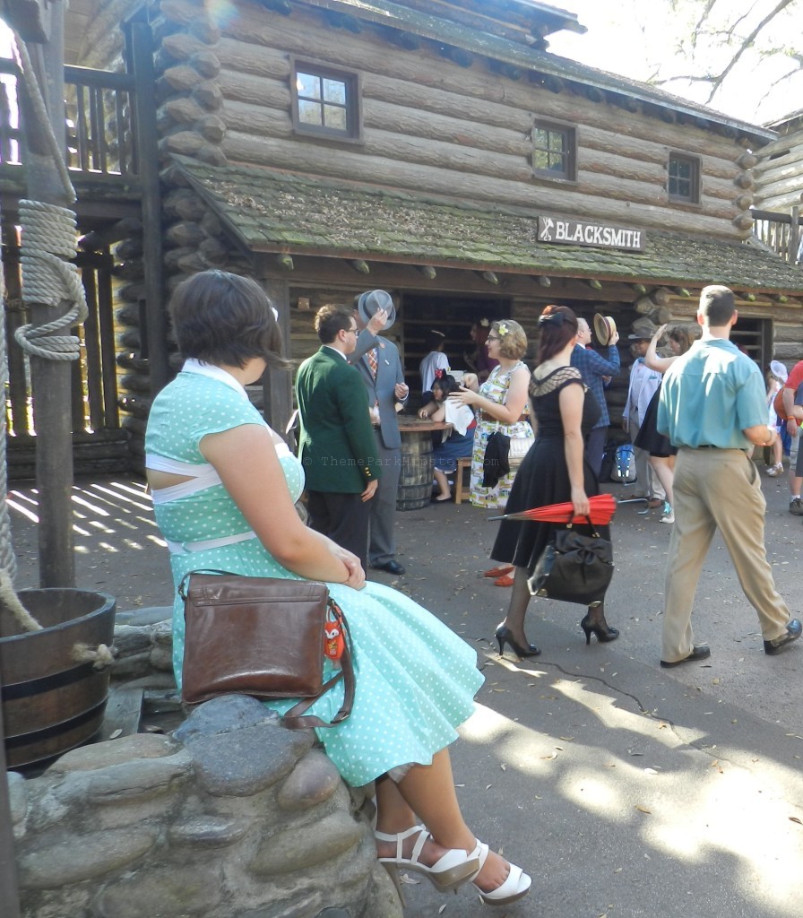 Tom Sawyer Island with lady dressed in Dapper Day polka dotted dress at the Magic Kingdom. Keep reading to get everything you must do at Magic Kingdom and the best things to do at Disney World.