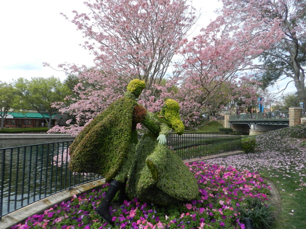 France Aurora and the Prince Topiaries in France Pavilion at Epcot. Keep reading to see the best epcot flower and garden topiaries through the years!