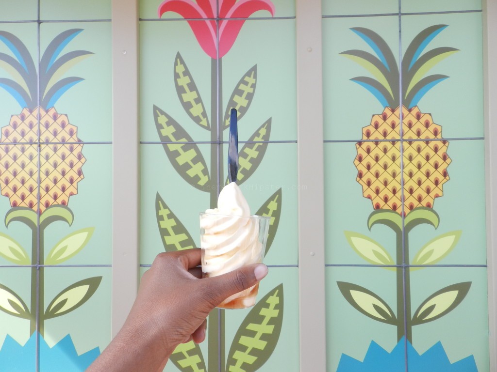 Dole Whip in many variations in front of pineapple painted wall at Disney World. Keep reading to get everything you must do at Magic Kingdom and the best things to do at Disney World.