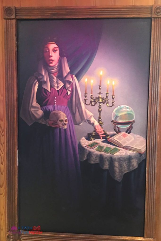Disney Memento Mori Shop at the Magic Kingdom with a painting of Madame Leota. Keep reading to learn about the Disney Haunted Mansion Magic Bands.