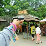 African Wine at Epcot Food and Wine Festival holding up wine with Disney gift card wristlet