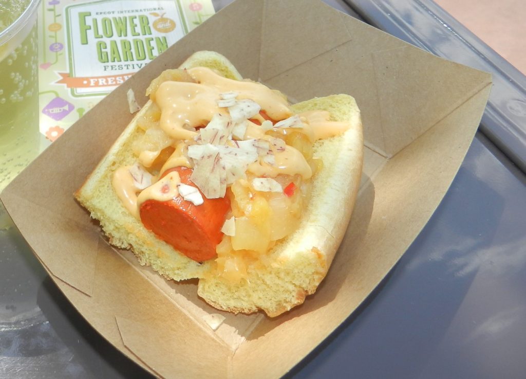 Pineapple Promenade Epcot Hot dog topped with pineapples at Epcot Flower and Garden Festival