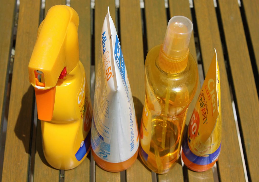 Sunscreen products sitting on a deck in the Florida summer heat.