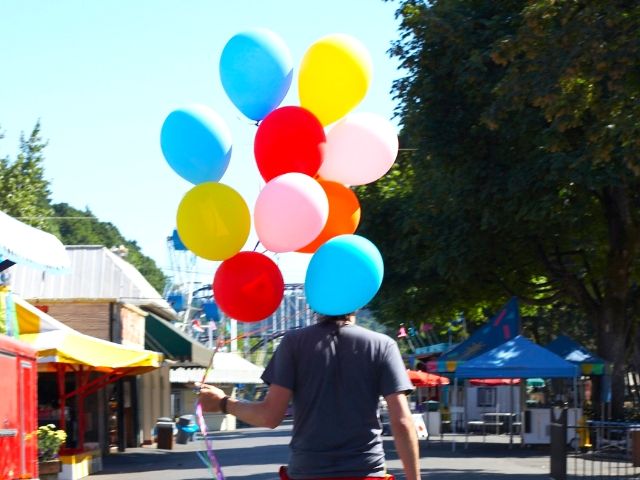 Self-Doubt Quotes with man on bike carrying red, blue, and yellow balloons