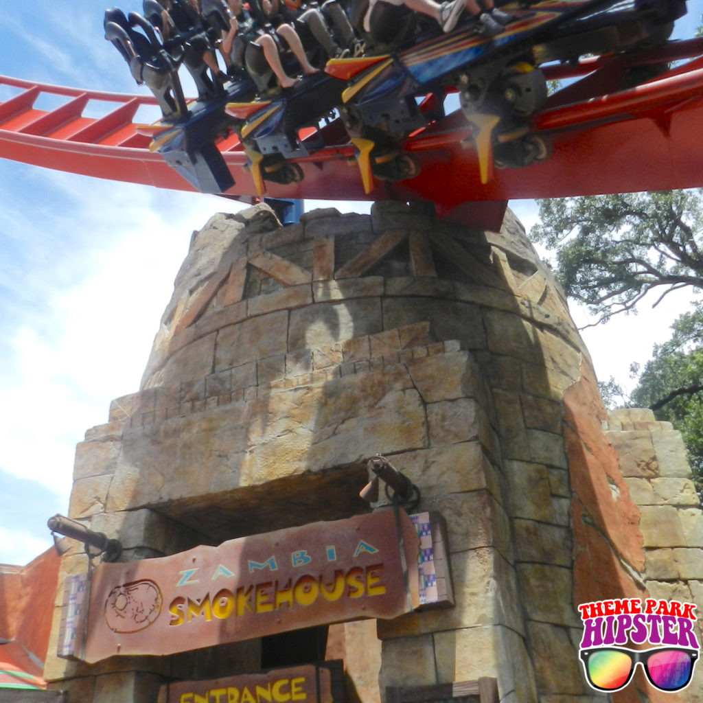 Zambia Smokehouse Busch Gardens with Sheikra roller coaster flying by.