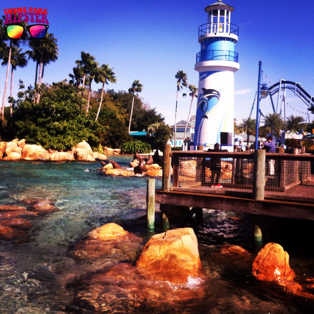 Classic SeaWorld Orlando Entrance with water and rock oasis with manta in the background.