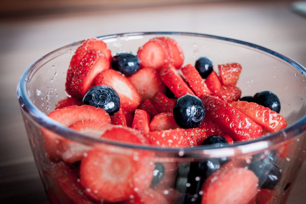 Bring snacks to Disney like these juicy red strawberries and blueberries to stay hydrated and save money on food.