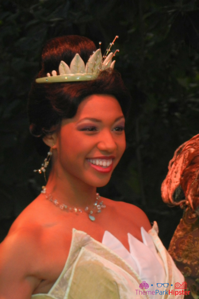 Princess Tiana in a beautiful gown at the Magic Kingdom. Keep reading to get the best movies to watch for Disney World Magic Kingdom.