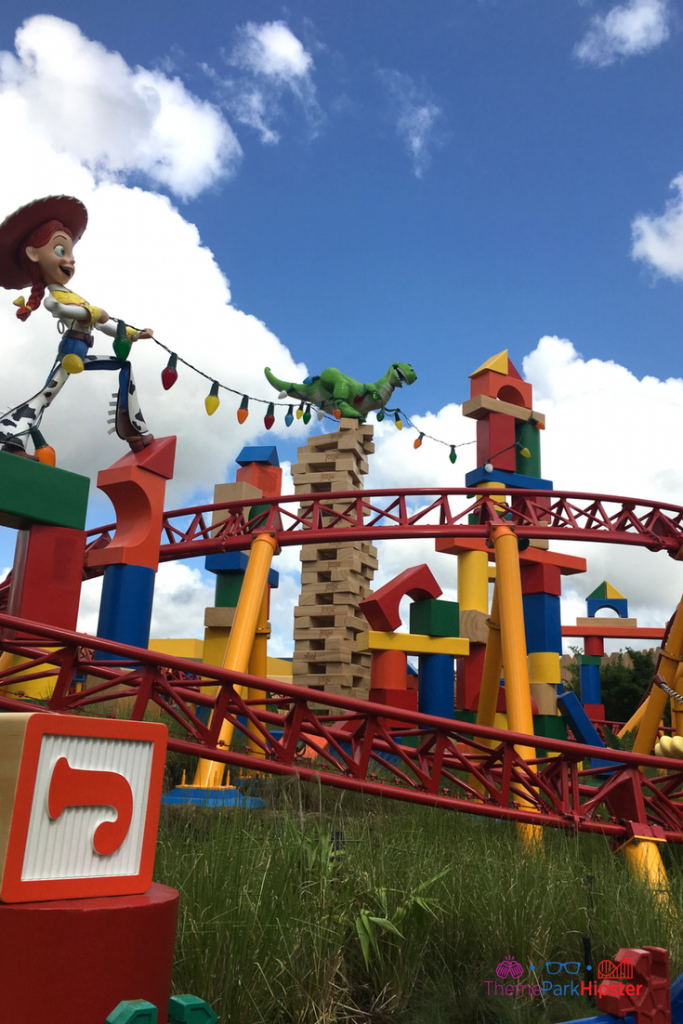 Jessie holding Christmas lights in Toy Story Land on Slinky Dog Dash. Keep reading to get the best rides at Hollywood Studios for Genie Plus and Lightning Lane attractions.