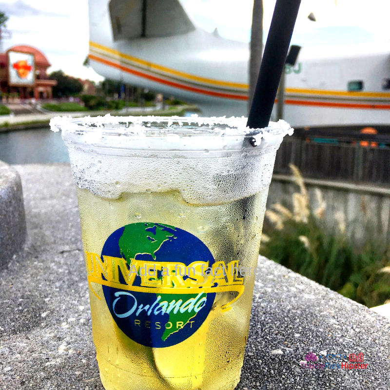 CityWalk Universal Orlando Margaritaville Delicious golden cocktail with lime. This is one of my favorite ways to do Universal Orlando on a budget.