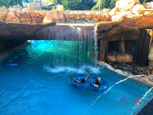 Aquatica SeaWorld Orlando Florida Water Park Blue Lazy River with Riders in Tube under Water Fall
