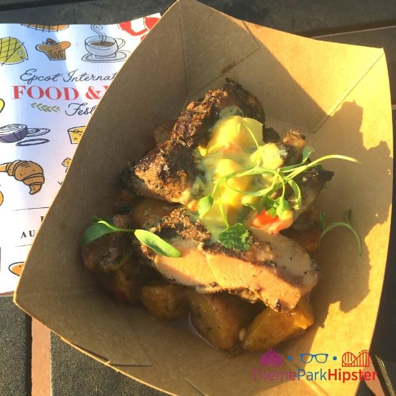 Jerk Chicken covered with mango salsa at Epcot Food and Wine Festival. Keep reading to learn more about the Epcot International Food and Wine Festival Menu.