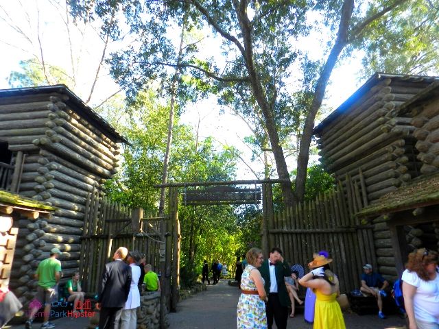 Disney World Tom Sawyer Island Fort with People Standing Around. Keep reading to learn how to dress for Dapper Day at Disney.