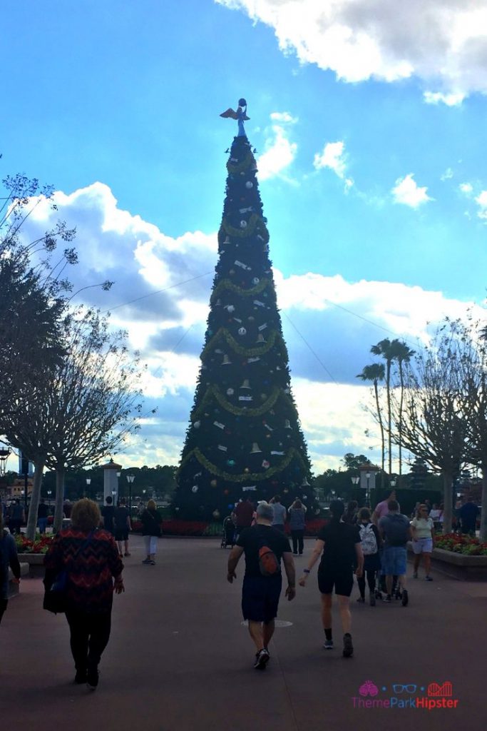 Epcot International Festival of the Holidays. World Showcase Entrance Holiday Decor Tall Christmas Tree. Keep reading to learn more about the Epcot Candlelight Processional and Christmas at Disney World. 