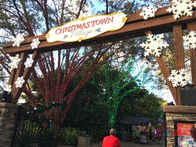2023 Christmas Town Village at Busch Gardens Entrance with snow. Keep reading to get the full guide on doing Christmas at Busch Gardens Tampa!