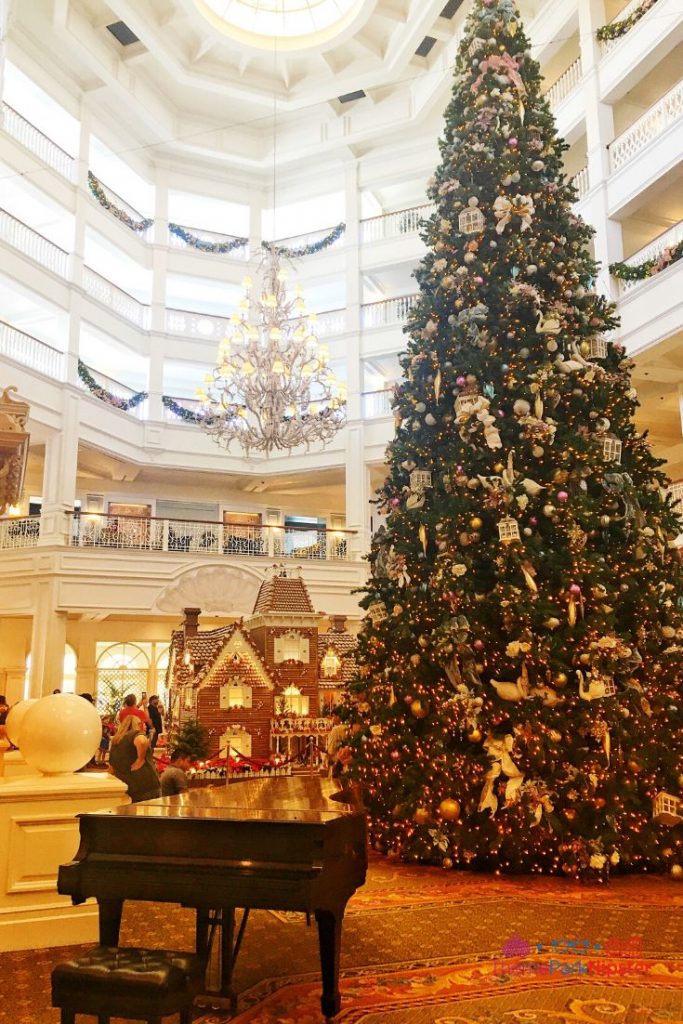 Grand Floridian Gingerbread House with Majestic Christmas Tree and Piano in the Lobby. Keep reading to learn more about your Disney Christmas trip and the Disney Christmas decorations.
