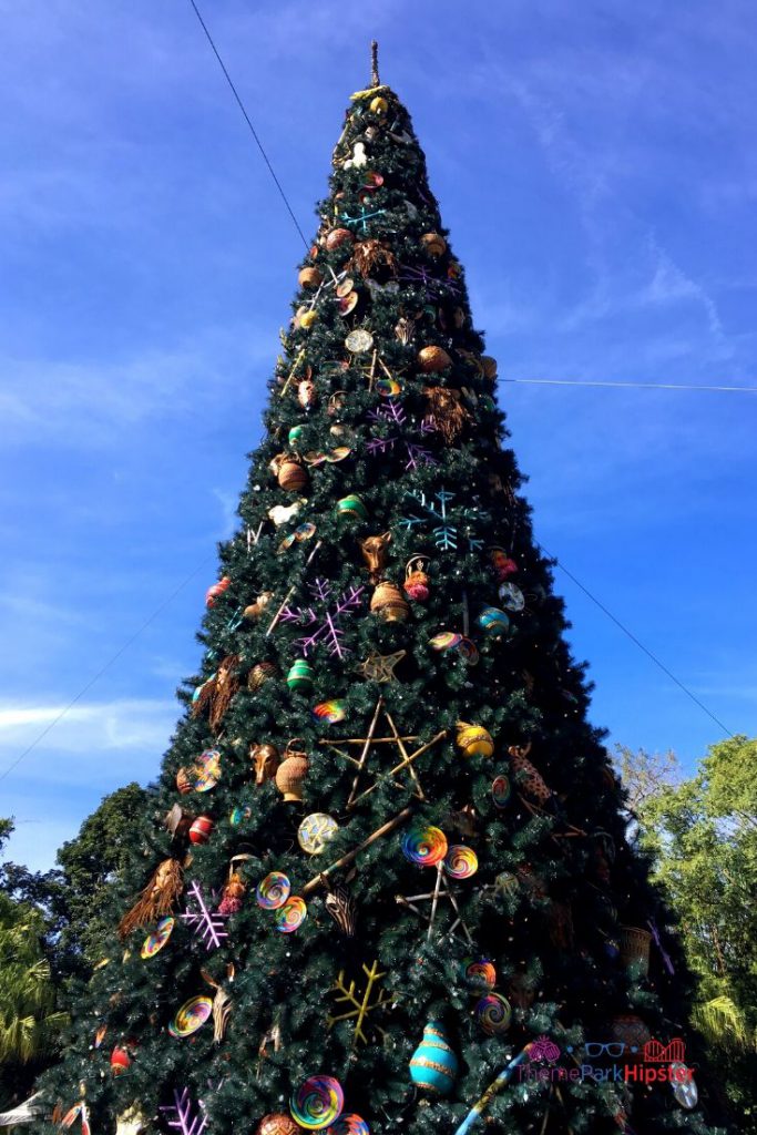 Animal Kingdom Christmas Tree in the Front Entrance. Keep reading to learn more about your Disney Christmas trip and the Disney Christmas decorations.