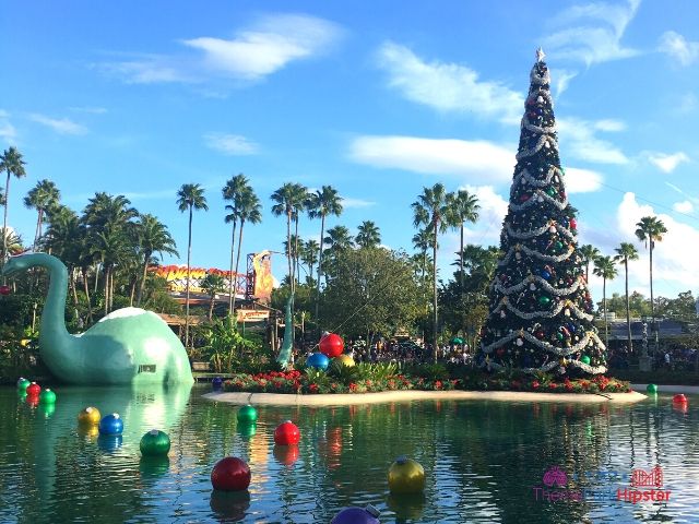 Christmas at Hollywood Studios Decorate Dinosaur in Santa Hat on Lake Echo. Keep reading to learn more about your Disney Christmas trip and the Disney Christmas decorations.