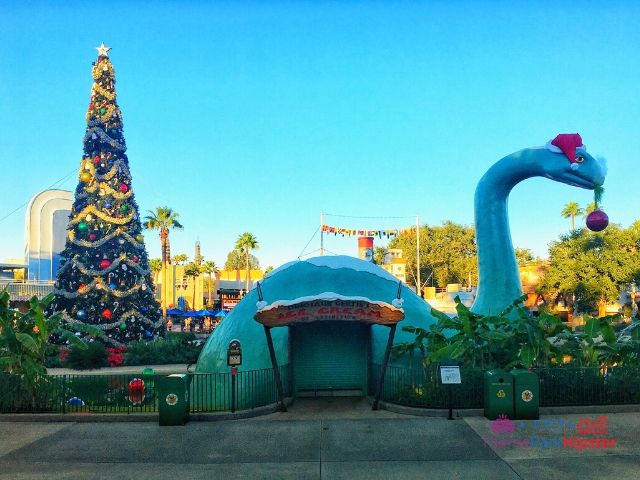 Dinosaur Gertie's Ice Cream Shop at Hollywood Studios with Christmas Tree in the background.