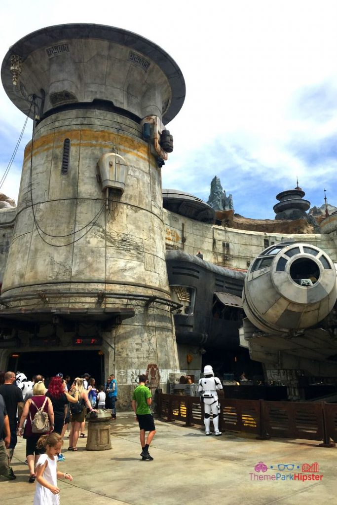Star Wars Galaxy's Edge Entrance to Smugglers Run with Millennium Falcon in the background and Storm Trooper 