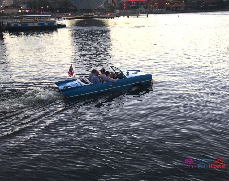 The Boathouse Orlando blue Amphicar in the water with tour driver dressed in vintage sailor attire. Keep reading to find out the 25 most romantic things to do at Disney World.