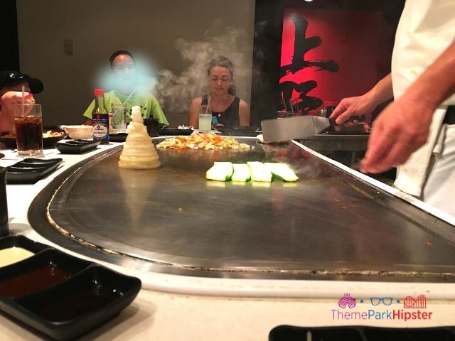 Epcot Japanese Restaurant Teppan Edo chef cooking hibachi. Keep reading to learn about the best Disney World restaurants for adults.