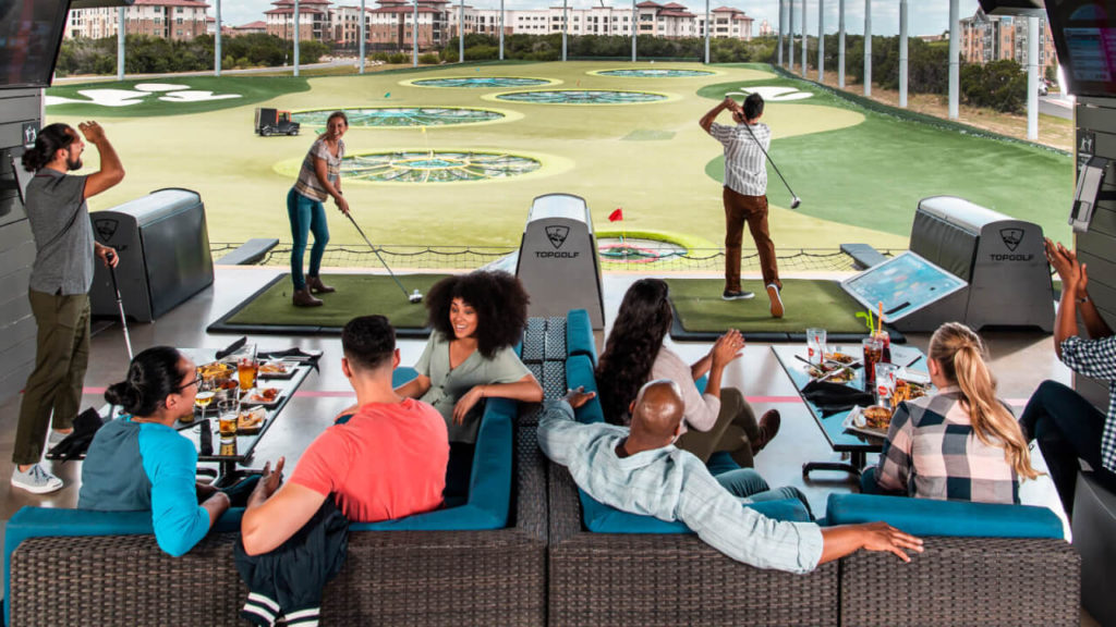 Top Golf with Adults Playing and Enjoying Food and Drinks