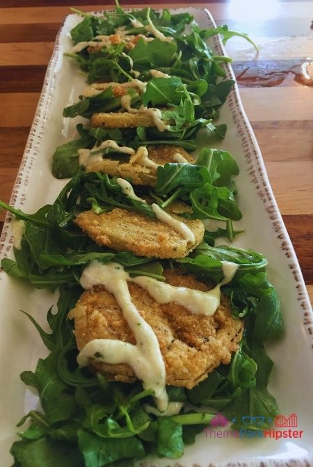 Homecomin Disney Springs Fried Green Tomatoes on a bed of arugula