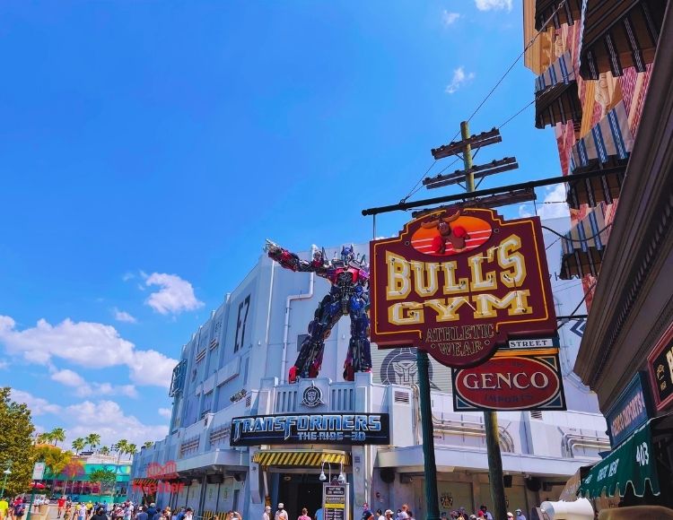 Transformers the Ride 3D Entrance next to Bull's Gym Sign. Keep reading to get the best Universal Studios Orlando, Florida itinerary and must-do list!