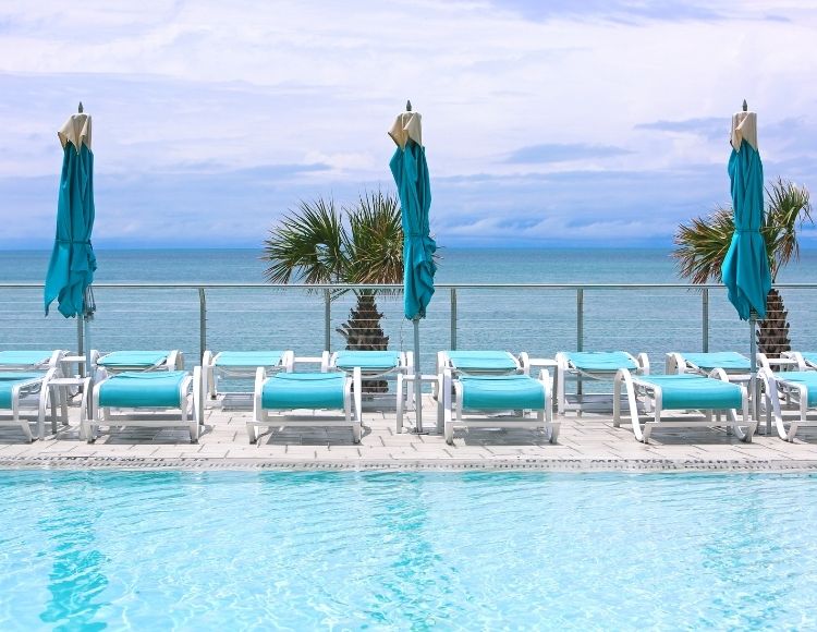 Clearwater Beach Florida ocean view from hotel pool. Keep reading to learn about the best beach close to Disney World and the Best Florida Beaches Near Disney World.