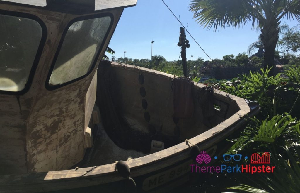 Typhoon Lagoon Shipwreck on green foliage. Keep reading to see what's the best Disney water park in our Typhoon Lagoon vs Blizzard Beach guide!