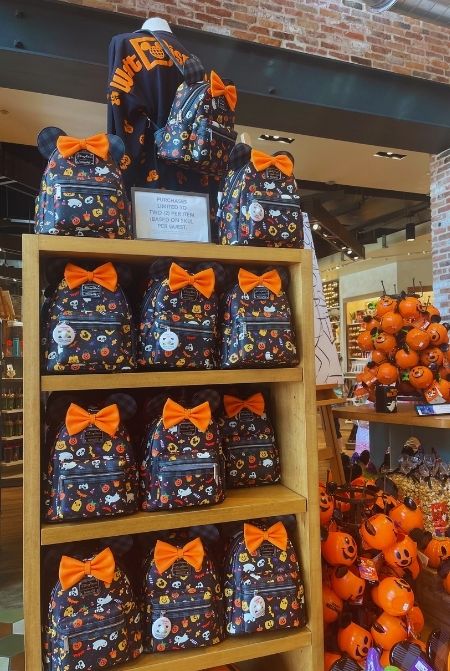 Loungefly Disney Halloween Purse Backpack. Keep reading to get the best Disney World souvenirs to buy for your trip!