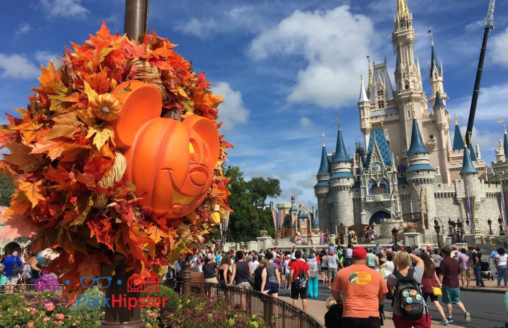 Mickey Mouse Halloween Pumpkin Head in front of Cinderella Castle. Best days to go to Magic Kingdom. Keep reading to know what are the best days to go to the Magic Kingdom and how to use the Disney World Crowd Calendar.