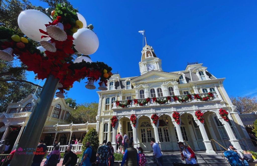 Cityhall Disney World Christmas decor in Magic Kingdom. Keep reading to learn how to do Thanksgiving Day at Disney World.