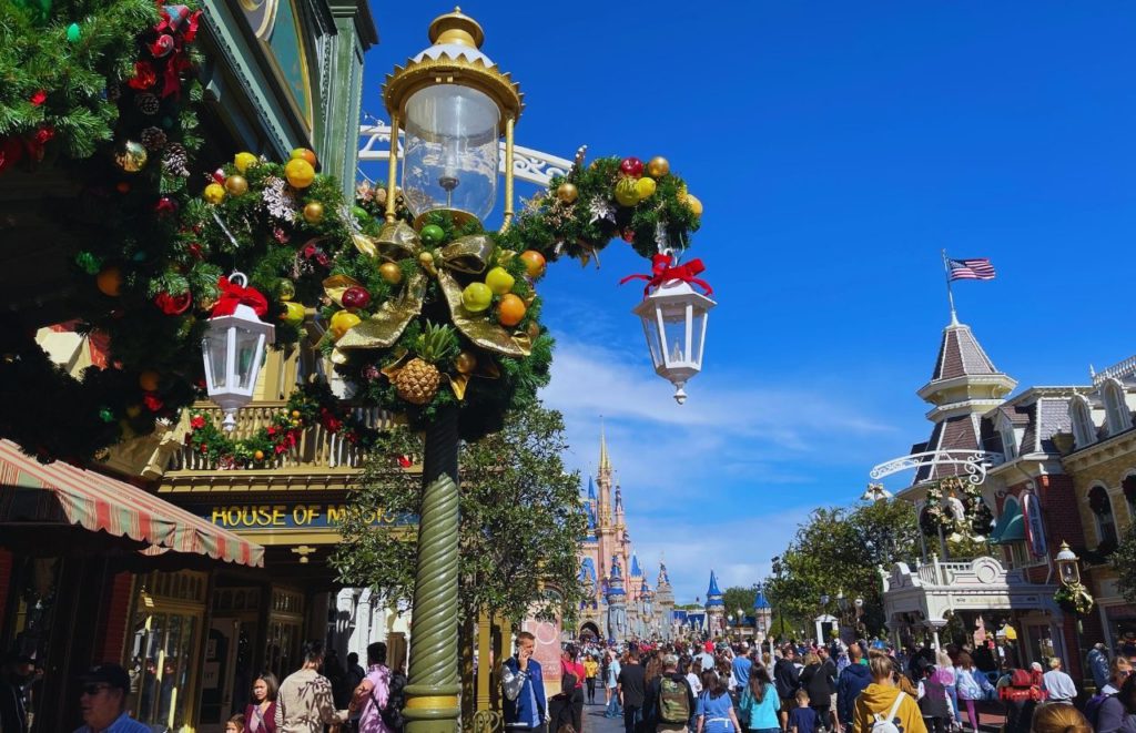 Disney Christmas decorations in Magic Kingdom with Cinderella Castle in the Background. Keep reading to learn about the best things to do at Disney World for Christmas.