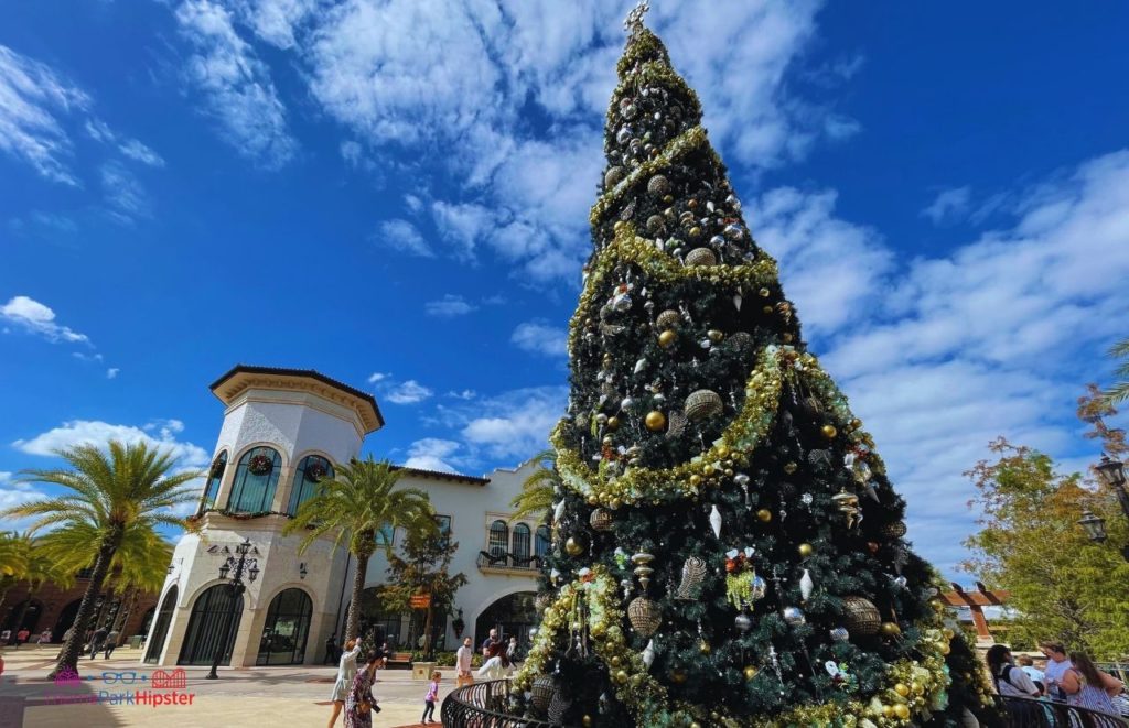 Disney Springs Main Christmas Tree with Zara Store in Background. Keep reading to learn about free things to do at Disney World and Disney freebies.
