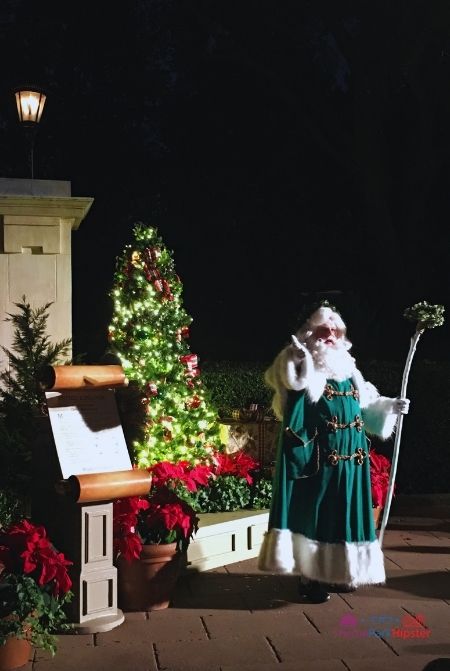 Epcot International Festival of the Holidays Santa Claus Story Teller in UK Pavilion. Keep reading to learn more about your Disney Christmas trip and the Disney Christmas decorations.