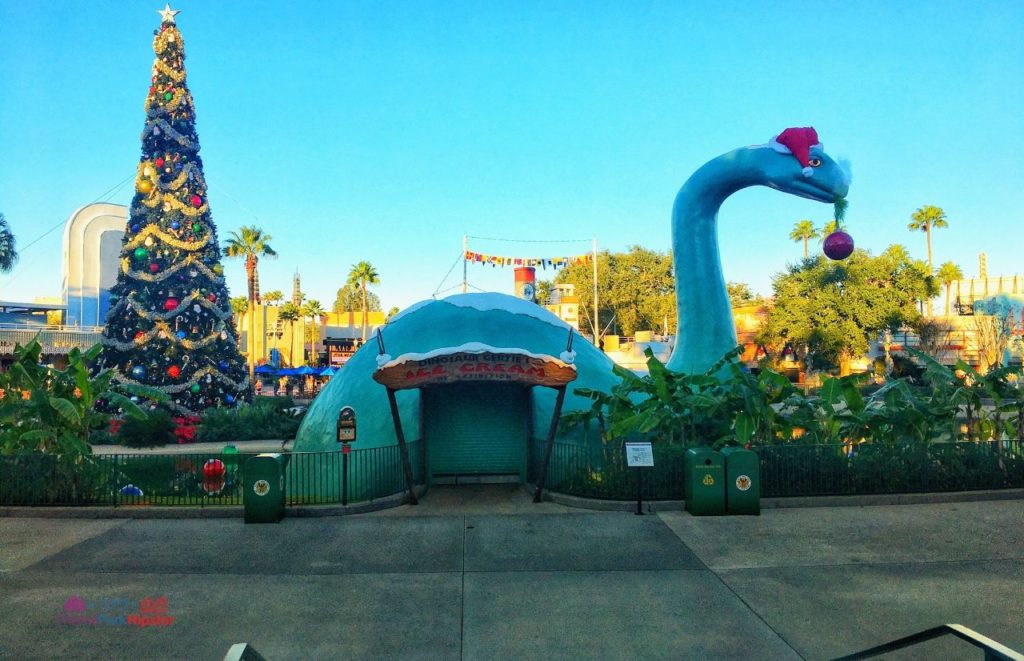 Gertie Dinosaur for Christmas at Hollywood Studios. Keep reading to get the best Disney Christmas pictures and to know where to take the best Christmas photos at Disney World!