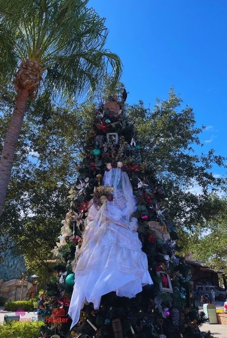 Haunted Mansion Christmas Tree in Disney Springs. Keep reading to get the best Disney Christmas pictures and to know where to take the best Christmas photos at Disney World!