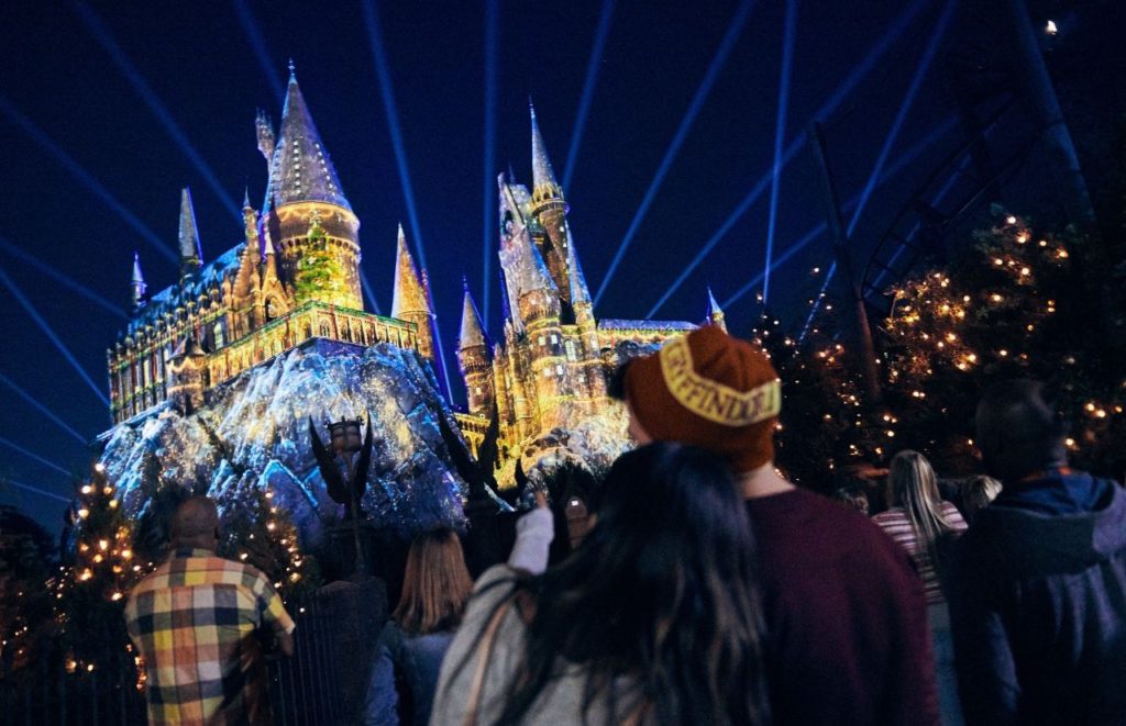 Hogwarts for Christmas Lights Show in Hogsmeade Wizarding World of Harry Potter. Keep reading to learn about Harry Potter World Christmas and The Magic of Christmas at Hogwarts Castle!