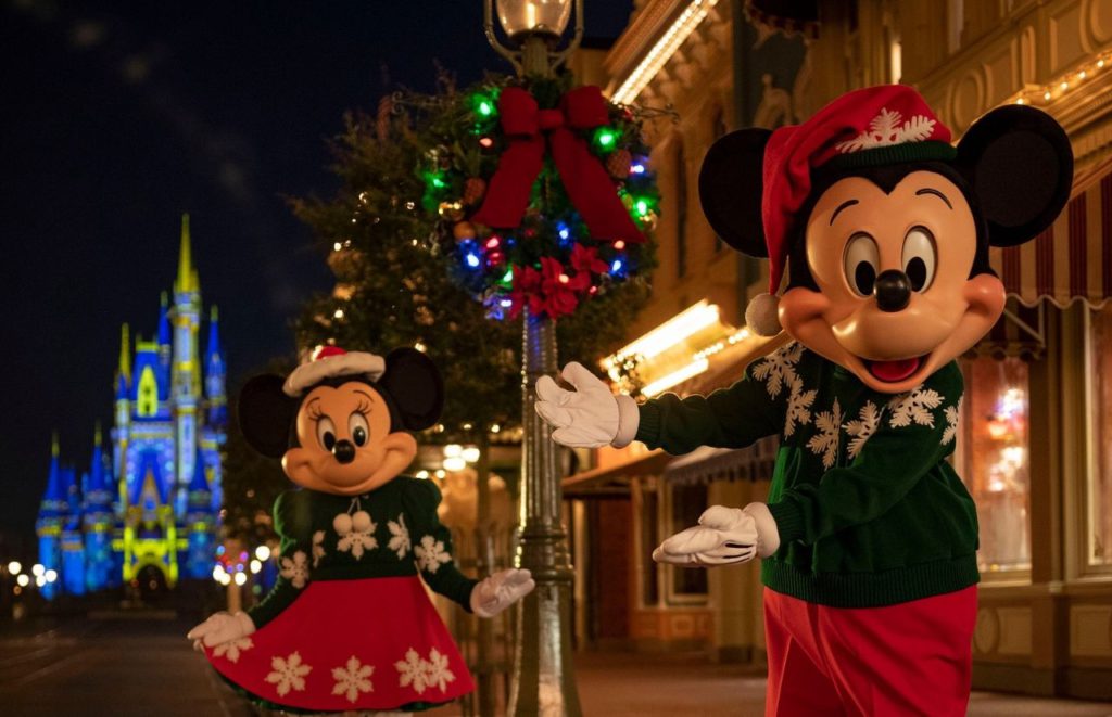 Mickey Mouse and Minnie Mouse on Main Street USA with Christmas Outfits at the Magic Kingdom Walt Disney World. Keep reading to learn about the best things to do at Disney World for Christmas.
