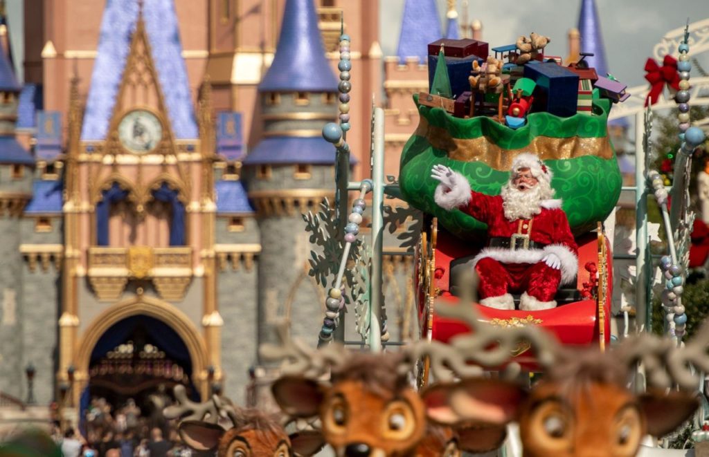 Santa and Reindeers during Disney Christmas Parade Magic Kingdom. Keep reading to know what to pack and what to wear to Disney World in December for your packing list.