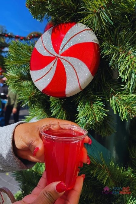 SeaWorld Christmas Celebration Holiday Cocktail in front of Christmas Tree