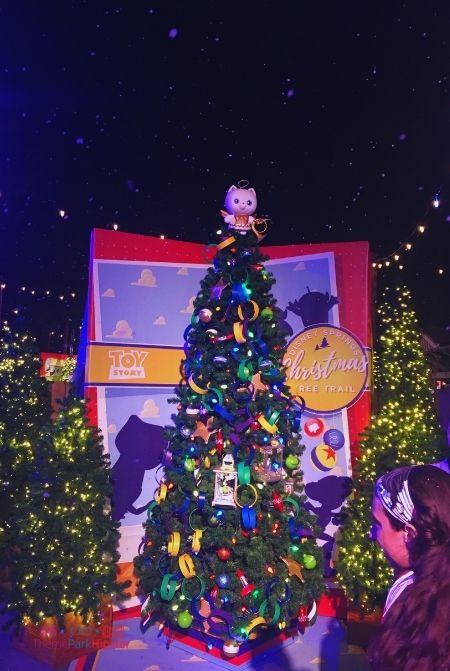 Snow in Disney Springs with Toy Story Christmas Tree. Keep reading to learn about the best things to do at Disney World for Christmas.