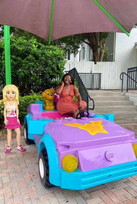 Victoria Wade in Lego Car at Legoland Florida. Keep reading to get the full guide to LEGOLAND Florida tips!