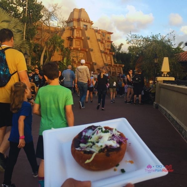 Mexican cheese and black black beans on top of flaky bread at Epcot Festival of the Arts. Keep reading to get the full Epcot Festival of the Arts guide, tips, food, concerts and more!